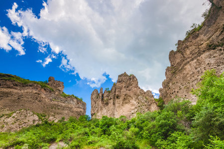 View on mountain cliffs and magnificent cloudy sky on background. Exploring Armenia