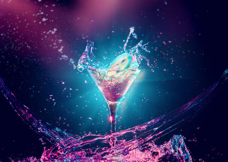 Colourful cocktail in glass with splash on the dark backgroundの写真素材
