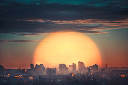 Aerial view of city sunset with big orange sun in Kiev, Ukraineの写真素材
