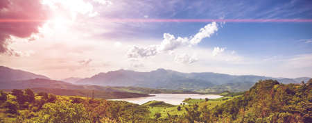 Green meadow, lake and blue sky with clouds. Exploring Armeniaの写真素材