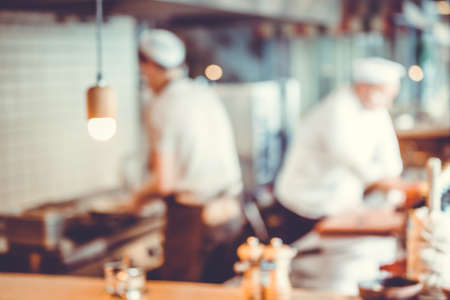 Blurred background : Group of chefs cooking in the kitchenの写真素材