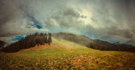 Dark rainy clouds in mountains landscape. Carpathian mountains, Ukraineの写真素材