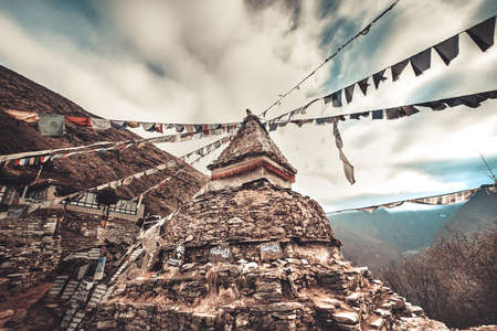 Prayer flags and buddhist stupa on the trekking route to Everest Base Camp. Himalaya Mountains, Nepal. Beautiful view from Khumbu valley, Solukhumbu, Sagarmatha national park. Retro vintage toningの写真素材