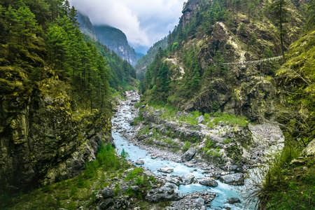 Mountain Canyon Valley. Beautiful river landscape and mountain forest in Nepal. Trekking route to Everest Base Camp, Himalayas. Holidays, recreation. Travel background. Beautiful nature landscapeの写真素材