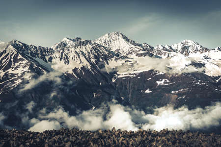 Panoramic summer landscape with mountain snowy peak, Svanetia region national park, Georgia. The main Caucasian ridge. Travel background. Dramatic natural landscape. Vinyage retro toning filterの写真素材