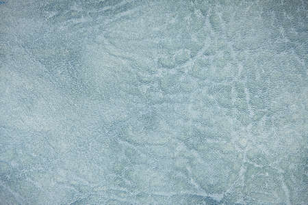 The colored heterogeneous leather texture. The fabric in light, dark blue and white tints. Artistic retouching. Perfect background for the different kinds of illustrations and collages.の写真素材