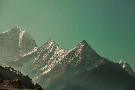 Ideal background in the emerald shade for the different kinds of collages, illustrations and digital media. The Thamserku Mountain, Himalayas. Eastern Nepal.の写真素材