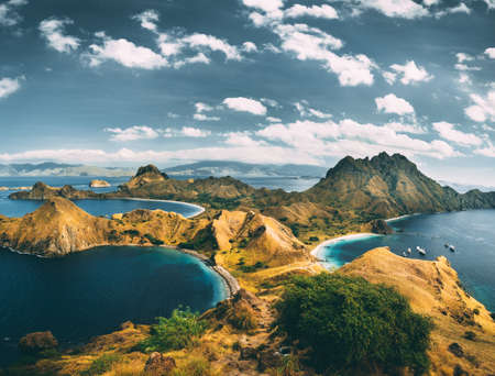 Bays, mountains, cloudy sky. Aerial shot. Padar. Spectacular panoramic overview the bays and mountains of the amazing Padar island of the Komodo National Park. Indonesia. Exotic place to visit.の写真素材