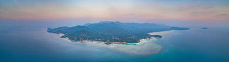 Panorama lone standing island. Sunset aerial drone shot. Ko Pha-ngan. Thailand. Overwhelmed view from above Ko Pha-ngan island and the ocean at the colorful sunset. The Kingdom of Thailand.の写真素材