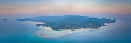 Panorama alone standing island. Sunset aerial drone shot. Ko Pha-ngan. Thailand. Overwhelmed view from above Ko Pha-ngan island and the ocean at the colorful sunset sky. The Kingdom of Thailandの写真素材
