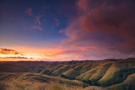 Colorful sunset sky over mountain panorama, Merdeka Hill, Bukit Wairinding, East Sumba, Indonesia. Travel Background. Nature landscape. Untouched wild islandの写真素材