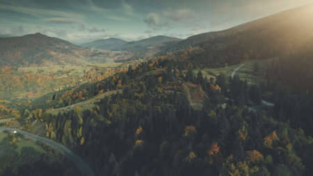 Autumn Forest Mountain Slope Village Aerial View. Panoramic Scenery Hill Meadow Landscape Sight. Wild Nature. Highland Scene of Building Clean Environment. Travel Concept Drone Flightの写真素材