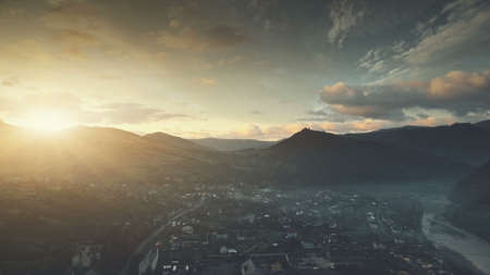 Mountain Suburban Town Cottage Sunrise Aerial View. Dawn Soft Sunlight Panoramic Countryside Village Overview. Peaceful Neighborhood Apartment Sight Tourism Concept. Drone Flightの写真素材