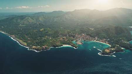 Aerial Drone Flight Above Tropical Island, Crystal Ocean, Harbor Bay and Green Forest Mountains. Travel Vacation Paradise Tourism. Exotic Nature Landscape. Beautiful Bali, Indonesia. Cinemaの写真素材