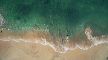 Aerial view of pink sand beach and blue crystal sea. Looping ocean surface texture. Top view waves slow motion. Tropical Bali Island, Indonesia. Travel Vacation Recreation Paradise Tourism Concept.の写真素材