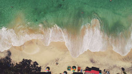 Aerial Drone View: Ocean Beach Waves in Sunny Day. White sand and crystal water landscape in Tropical Bali Island, Indonesia. Travel Vacation Recreation Paradise Tourism Concept. Top downの写真素材
