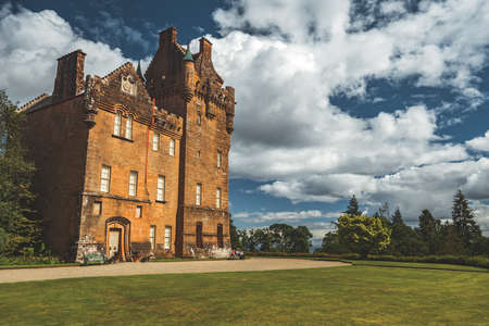 Beautiful Medieval Historic Castle Nothern Ireland. Exterior of Antique Historical Vintage House, Green Grass and Trees, Cloudy Sky. Irish Traditional Monument. Amazing Landscape Photoの写真素材