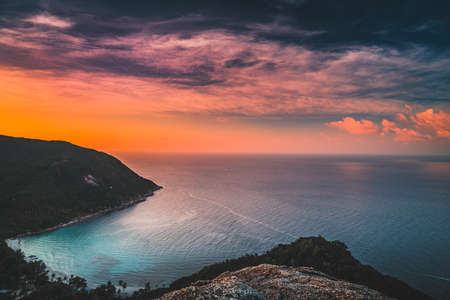 Sunset Bottle Beach on Phangan Island Thailand Nature Landscape. Asian Tropical Tourist Coastline, Tropical Wood and Mountains. Amazing View from Rock on Sea. Panoramic Photo on Ocean and Cloudy Skyの写真素材