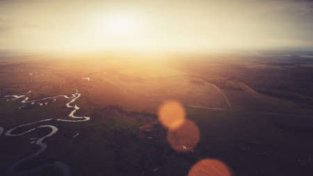 Aerial View Drone Flight: high shooting of Beautiful River and Green Meadows in dramatic sunset light with sun beams. Turn right. Ukraine, Europe. Beauty world. Nature landscapeの写真素材