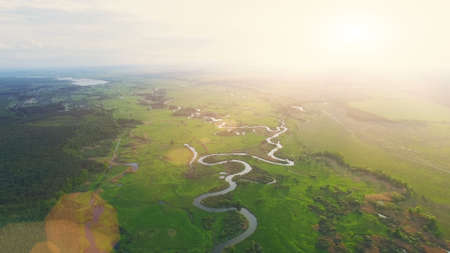 Aerial View Drone Flight: high shooting of Beautiful River and Green Meadows in sunset soft light with sun beams. Turn right. Ukraine, Europe. Beauty world. Magestic landscapeの写真素材