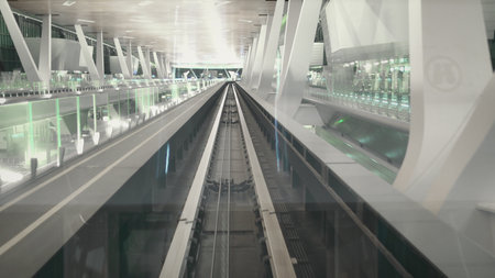 View from Modern Automatic Train Front Window. Inter Terminal Transparent Shuttle Service. Airport Express Connection. High Speed Futuristic Driverless Transport Moving.の写真素材