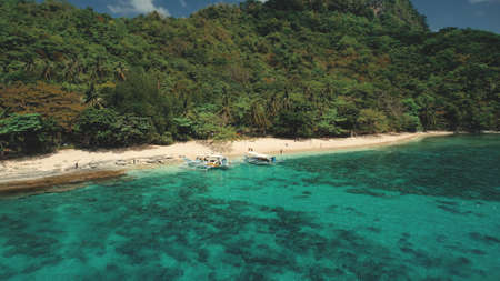 Tropical Philippines Mountain Islands at sea bay aerial view. Green forest on hilly ranges at sunny day. Serene seascape of Palawan Islets, Philippines, Asia. Cinematic summer vacation sceneryの写真素材