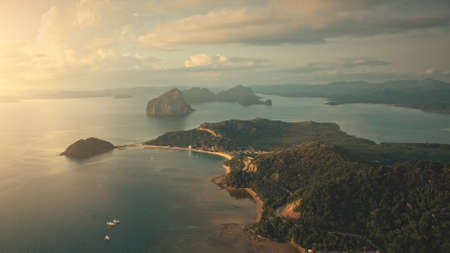 Sunrise at tropical ocean bay islands aerial view. Mountainous islet with exotic plants, forest on ranges at sun rise. Paradise cityscape at Palawan, El Nido, Philippines archipelago, Asiaの写真素材