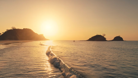 Sun reflection at waves of ocean bay aerial. Silhouette of mountains islands with tropic forest. Seascape with rock islets of Philippines archipelago. Summer marine at sunshine. Travel to paradiseの写真素材