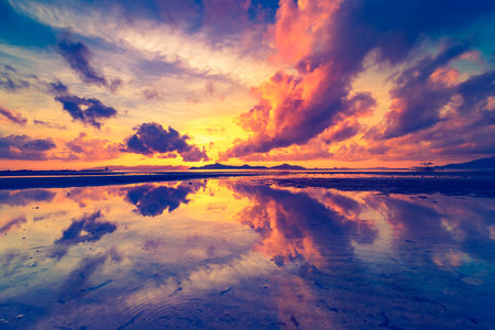 Thailand sunrise silhouette aerial: ocean gulf waterfront with sky reflection. Asian island scenic sun rise with boat on water surface. Amazing nobody nature landscape in cinematic sort shotの写真素材