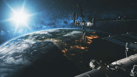International Space Station Earth satellite with bright sun at cosmos over planet of Solar system in spatial explore mission. Stars and Milky Way at background.の写真素材
