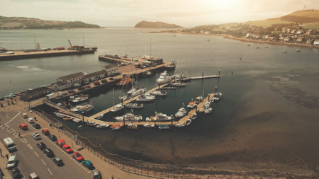 Seascape with yachts, ships on harbor. Aerial cityscape with modern buildings at downtown streets. Traffic road at dock aerial. People walk down of sea bay highway. Cars and vans drive on roadwayの写真素材