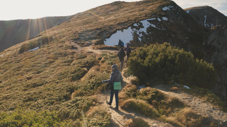 Tourist dance on mountain sun top closeup aerial. Autumn nature landscape. People hike to mount peak. Travelers lifestyle. Mountaineering vacation. Travel, tourism scene. Carpathians, Ukraine, Europeの写真素材