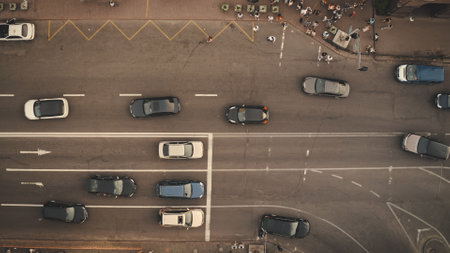 Top down pedestrians crosswalk road aerial. People cross street. Cityscape crossroad. Men, women walking at zebra. Busy town residentes lifestyle. Downtown of Kyiv city, Ukraine, Europeの写真素材