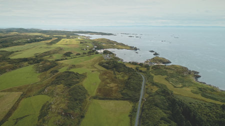 Alcohol industy at sea bay aerial. Whiskey distillery at countryside. Green forest and fields at rural farmlands. Nobody nature landscape. Port town Ellen, Islay Island, United Kingdom, Europeの写真素材