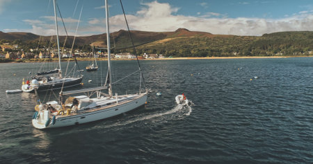 Closeup aerial of luxury yacht and sail boat on sea bay at summer sunny day. Sailboats regatta...