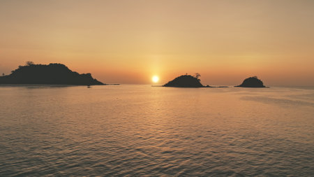 Timelapse of sunset seascape at mountain island silhouette aerial. Nobody nature landscape of Philippines, El Nido Isle, Visayas Archipelago. Waves at ocean bay. Sea waves at summer eveningの写真素材