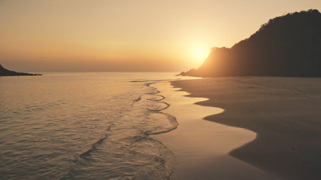 Slow motion sunset seascape at mountain island aerial. Tropic nobody nature landscape at summer sun set light evening. Ocean waves at sand beach. Cinematic El Nido Island, Philippines, Asiaの写真素材
