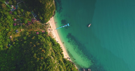 Breathtaking aerial view capturing the pristine beauty of a tropical beach, lush vegetation, a vibrant pier, and tranquil turquoise waters of Moo Koh Ang Thong National Marine Park in Thailandの写真素材