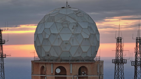 Malta: Large geodetic dome protecting a radar antenna at sunset, with radio towers and other communication equipment in the foreground, in Malta. Drone flightの写真素材