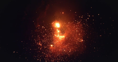 Aerial drone capturing a volcano erupting at night, showering the dark sky with incandescent lava and lapilli, creating a dramatic fiery glow. Amazing nature travel backgroundの写真素材