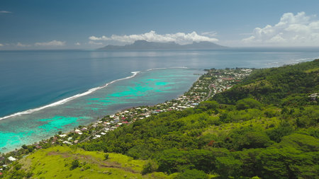 Stunning beauty of Tahiti island hills covered by lush green vegetation, vibrant turquoise lagoon coral reef, and majestic Moorea island. Remote wild nature paradise, exotic summer travel. Aerialの写真素材