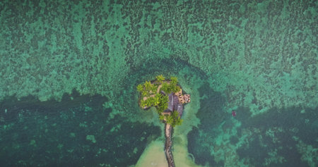 Fiji: luxurious overwater bungalow resort on tropical island, surrounded by crystal clear turquoise...