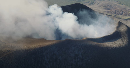 Tanna Island: Aerial view Yasur Volcano releasing a massive plume of smoke and ash, showcasing the...