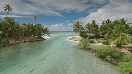 Shallow river channel flowing into turquoise water of blue ocean in Fakarava, UNESCO biosphere...