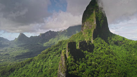 Breathtaking beauty of Moorea mountain landscape, covered by green forest hills and rugged stone...
