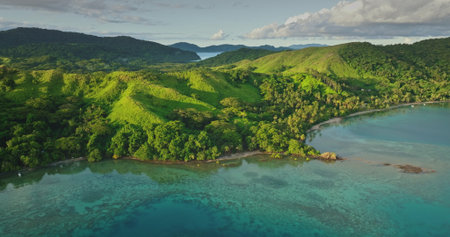 Fiji islands: Aerial drone of a Fiji island showing the turquoise water coast and the green hills...