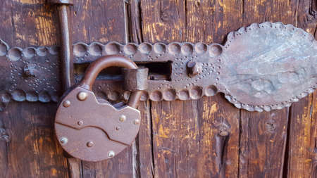 Old vintage lock on a wooden doorの写真素材