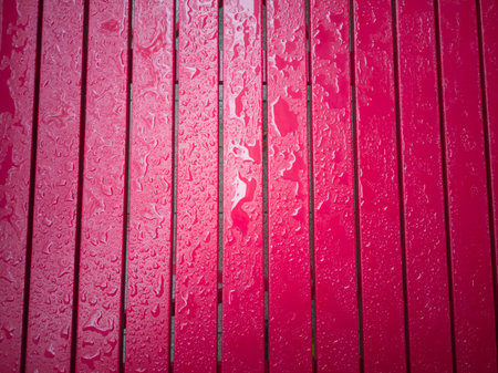 Close-up drops of water on red wooden background. November 18, 2018.