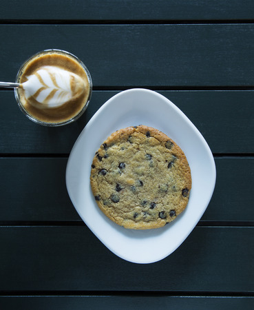 latte served on table with cookieの写真素材