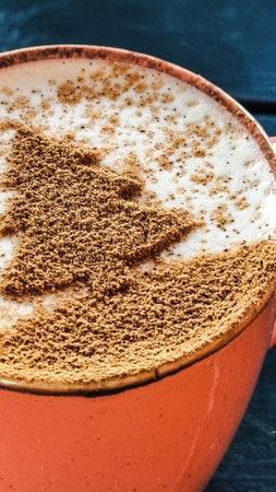 Latte Art. Pattern, drawing on coffee in the form of a Christmas tree. Christmas drink A cup of latte art in a cup in the snow.の写真素材